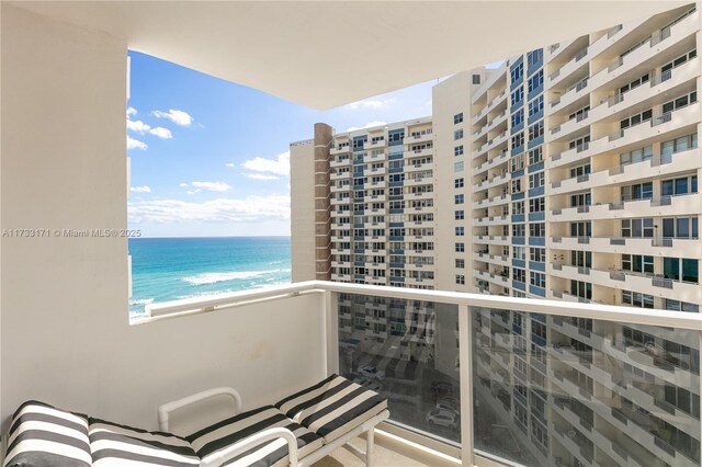 balcony with a view of the beach and a water view