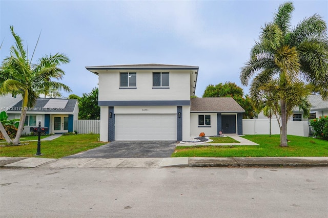 view of front of property with a garage and a front yard