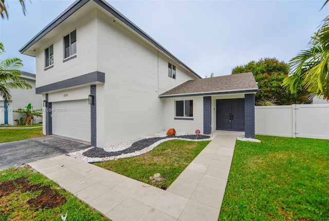 view of front of house with a garage and a front yard