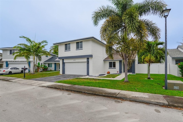 view of front of home featuring a garage and a front lawn