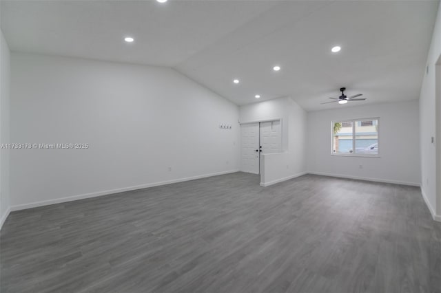 spare room with ceiling fan, dark hardwood / wood-style flooring, and vaulted ceiling