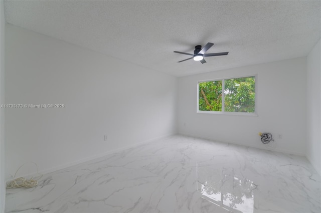 empty room featuring ceiling fan and a textured ceiling