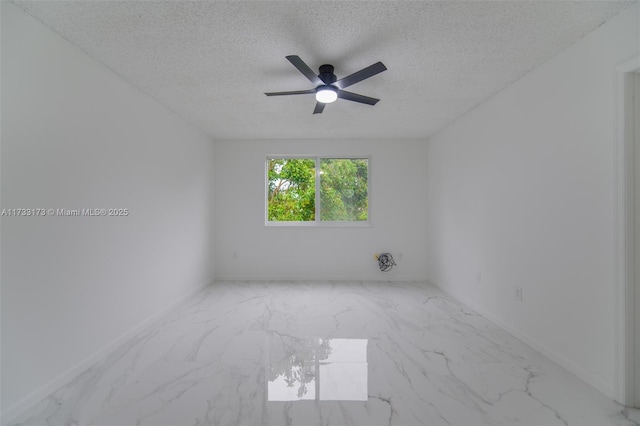 spare room featuring ceiling fan and a textured ceiling