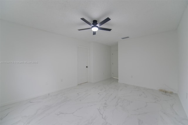 spare room with a textured ceiling and ceiling fan