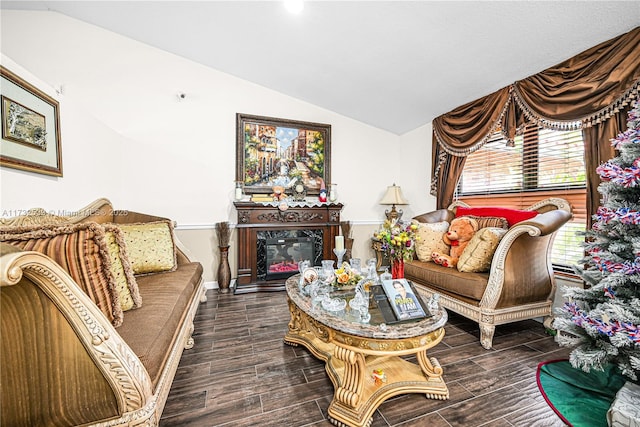 living room featuring vaulted ceiling and a premium fireplace