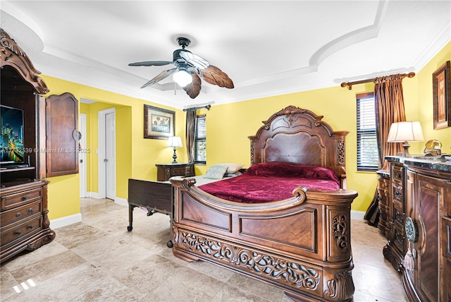 bedroom with a raised ceiling, crown molding, and ceiling fan