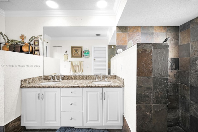 bathroom featuring vanity, ornamental molding, a textured ceiling, and walk in shower