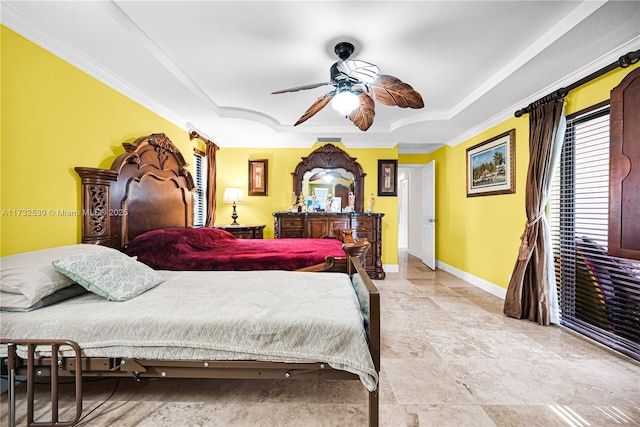 bedroom with ornamental molding, a raised ceiling, and ceiling fan