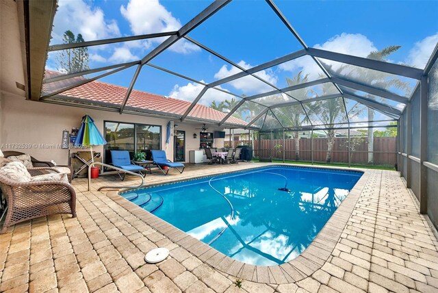 510 NW 105th Dr, Coral Springs, FL 33071 - view of pool with ceiling fan, glass enclosure, a patio, a fenced in pool, and fence private yard