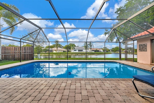 view of pool with a water view, a lanai, and a patio