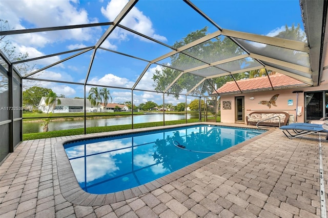 view of swimming pool with a water view, a patio, and a lanai