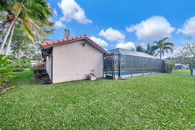 exterior space with a fenced in pool, a lanai, and a yard