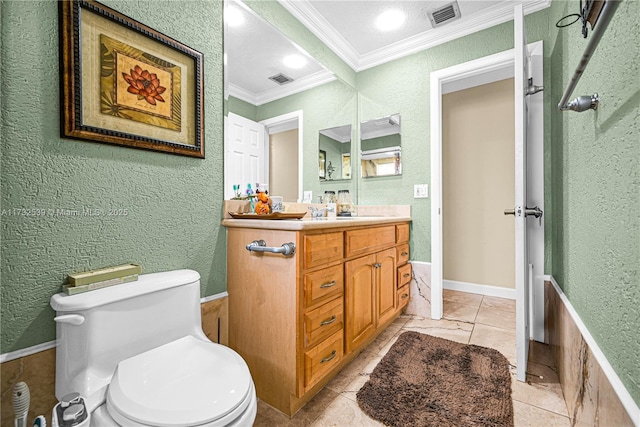 bathroom featuring vanity, tile patterned floors, ornamental molding, and toilet