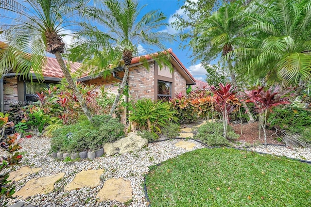 view of side of home with a yard