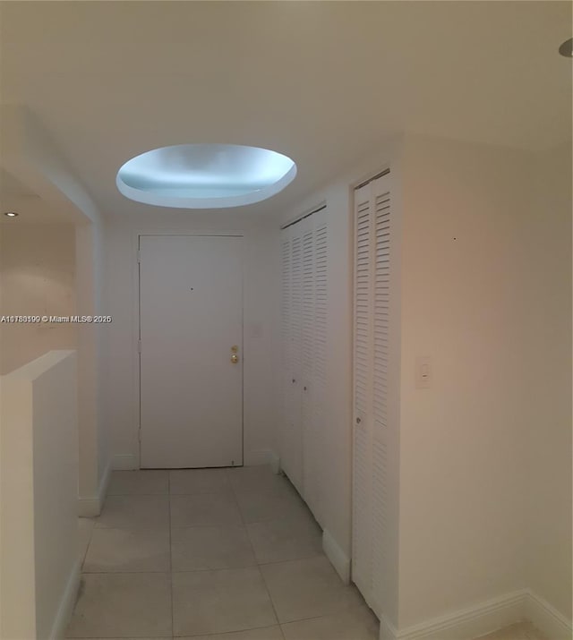 corridor featuring light tile patterned flooring