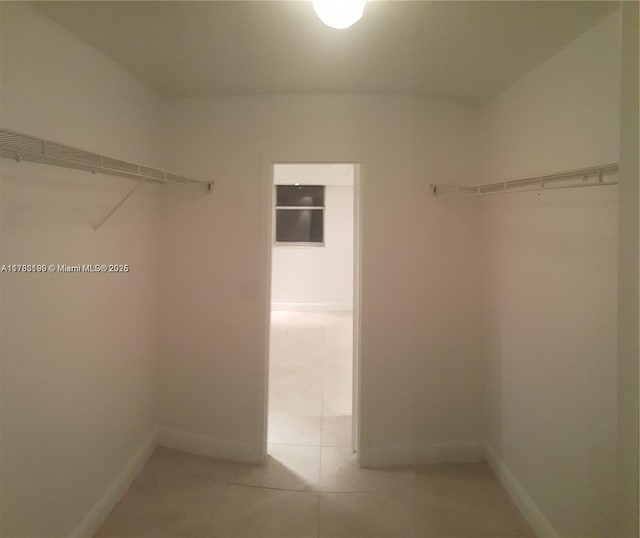 walk in closet featuring light tile patterned floors