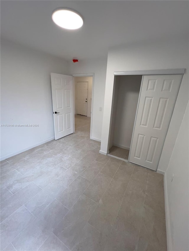 unfurnished bedroom featuring a closet