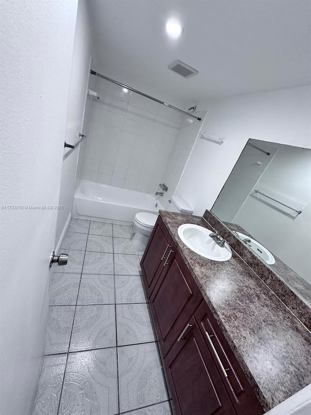 full bathroom with vanity, toilet, and tiled shower / bath combo