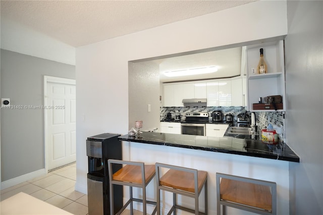 kitchen featuring sink, white cabinetry, light tile patterned floors, electric range, and kitchen peninsula