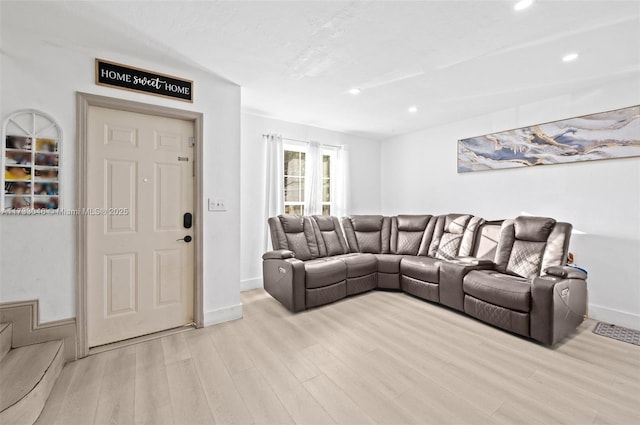 living room with recessed lighting, light wood-style flooring, and baseboards