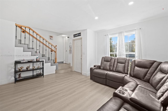 living room featuring recessed lighting, stairway, light wood-style flooring, and baseboards