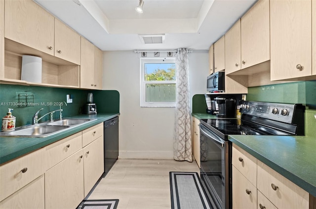 kitchen featuring light brown cabinetry, a sink, appliances with stainless steel finishes, a raised ceiling, and backsplash