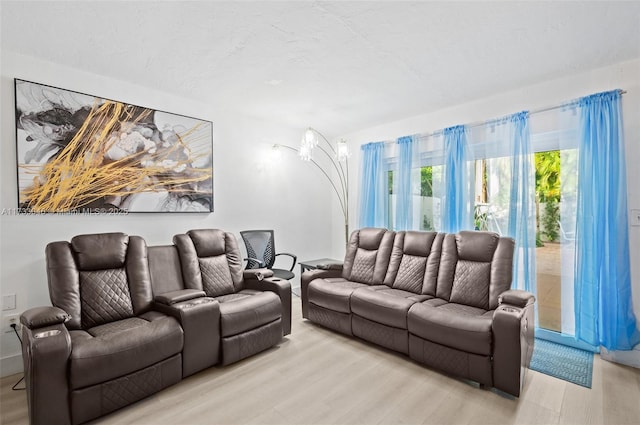 living area with light wood-style flooring and a textured ceiling