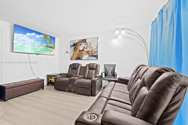 living room with an inviting chandelier and light wood-style flooring