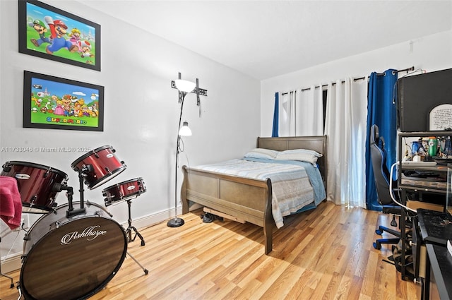 bedroom with wood finished floors and baseboards