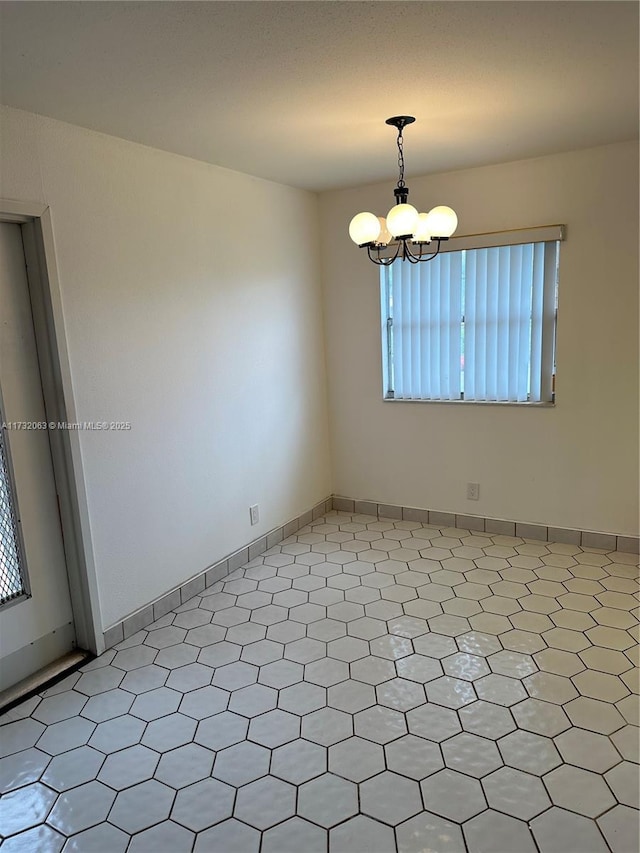 empty room featuring a chandelier