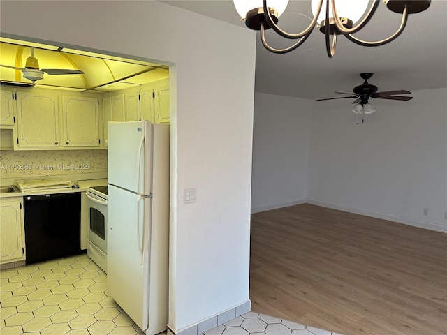 kitchen with white appliances, ceiling fan with notable chandelier, and backsplash