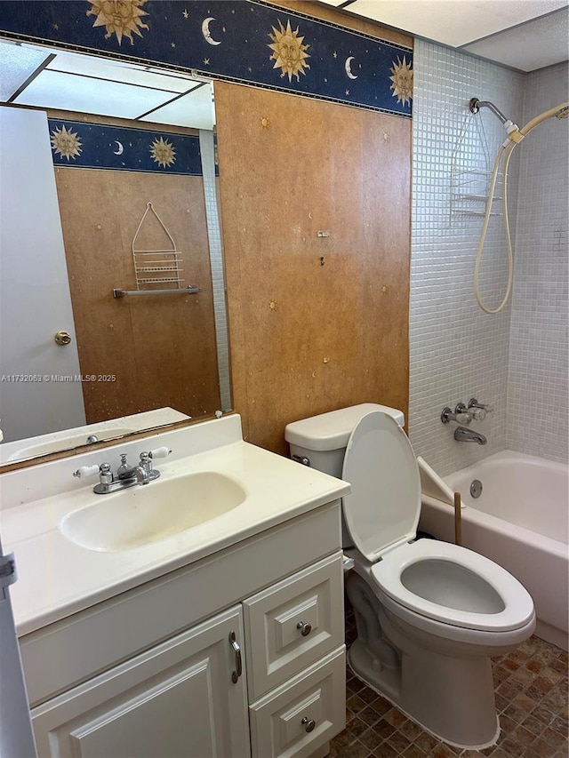 full bathroom featuring vanity, toilet, and tiled shower / bath combo