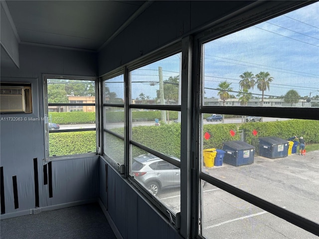 sunroom / solarium with a wall mounted air conditioner