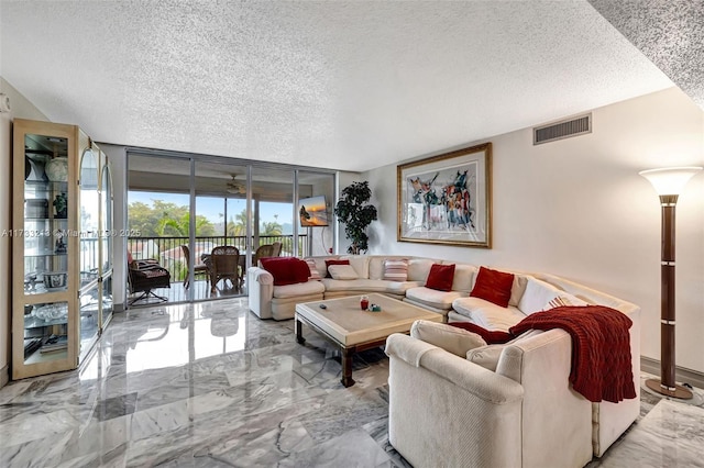 living room featuring floor to ceiling windows and a textured ceiling