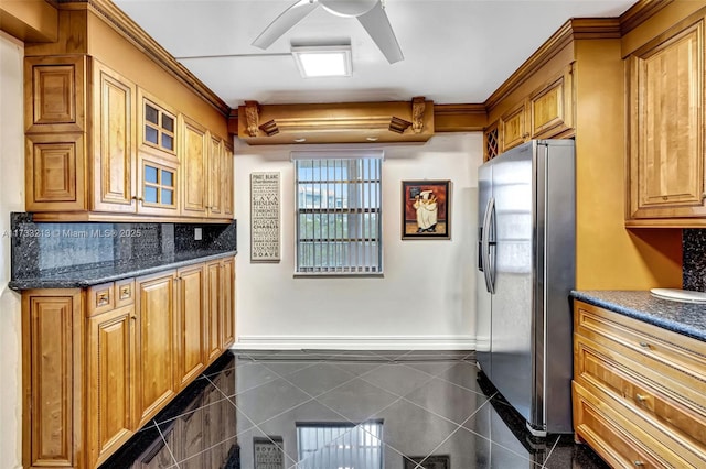 kitchen featuring tasteful backsplash, dark stone countertops, stainless steel fridge, dark tile patterned floors, and ceiling fan