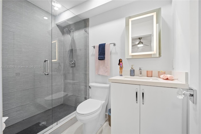 bathroom featuring vanity, an enclosed shower, and toilet