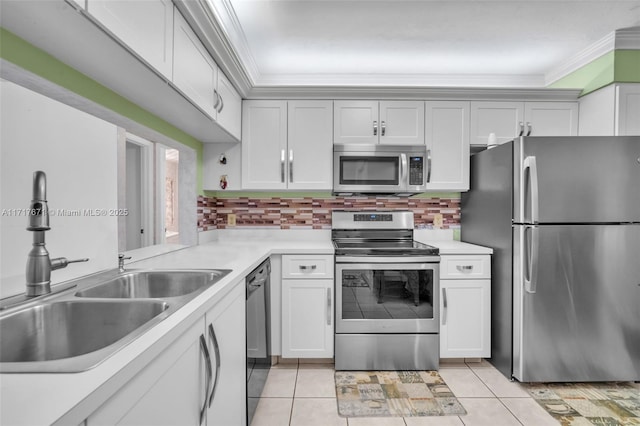 kitchen featuring crown molding, stainless steel appliances, light tile patterned flooring, and sink