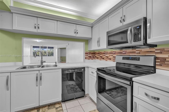 kitchen featuring white cabinetry, appliances with stainless steel finishes, sink, and backsplash