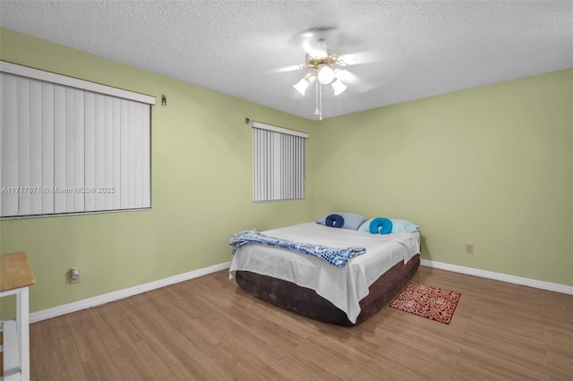 bedroom featuring a textured ceiling and ceiling fan