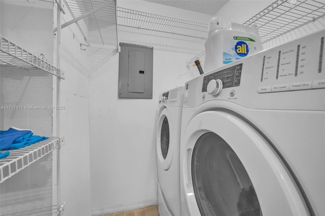 clothes washing area featuring washer and dryer, electric panel, and a textured ceiling