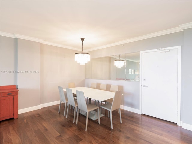 dining room with a notable chandelier, crown molding, and dark hardwood / wood-style floors