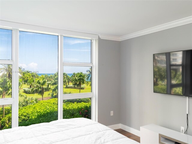 bedroom with crown molding and hardwood / wood-style flooring