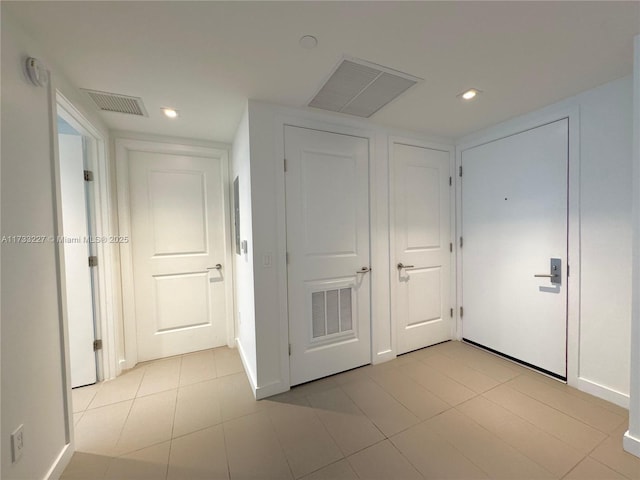 hall featuring light tile patterned floors