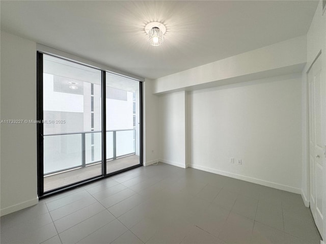 unfurnished room featuring expansive windows