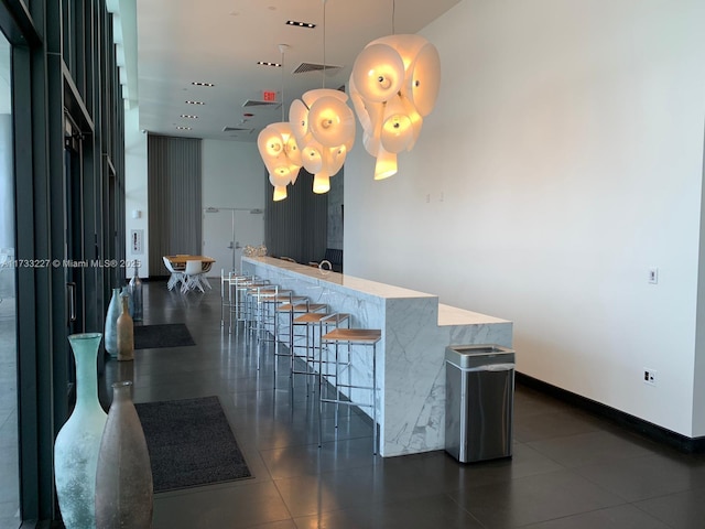 kitchen with a breakfast bar and hanging light fixtures