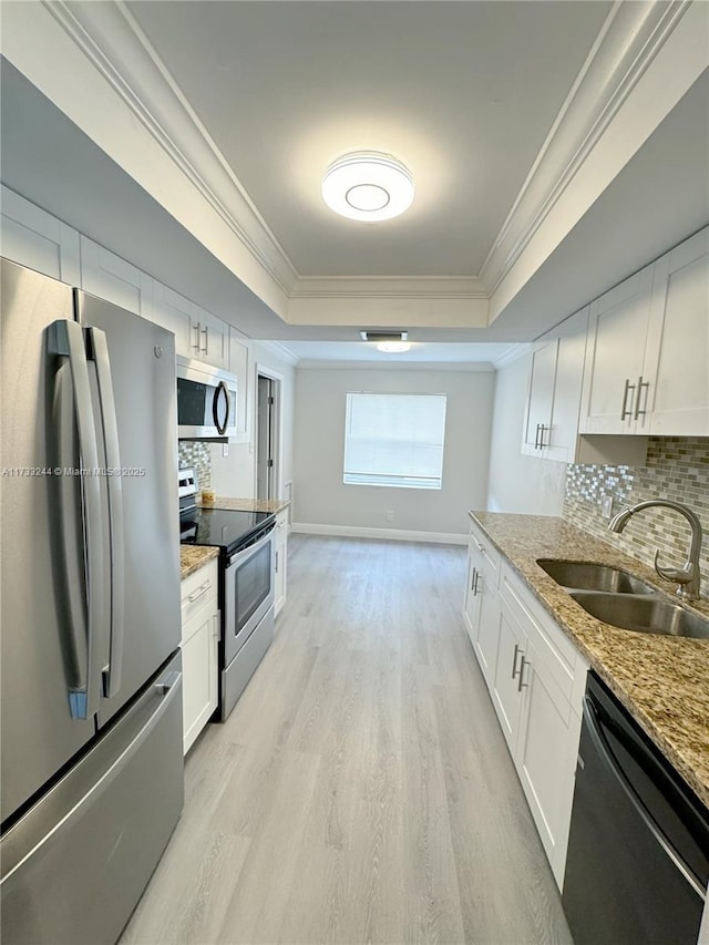 kitchen featuring stainless steel appliances, white cabinetry, and sink