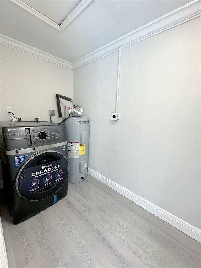 laundry room featuring water heater, crown molding, washer / dryer, and light wood-type flooring