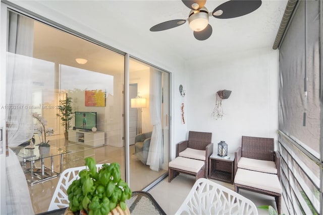 sunroom / solarium featuring ceiling fan