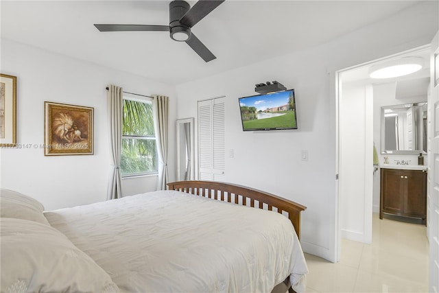 bedroom featuring ceiling fan, ensuite bathroom, and a closet