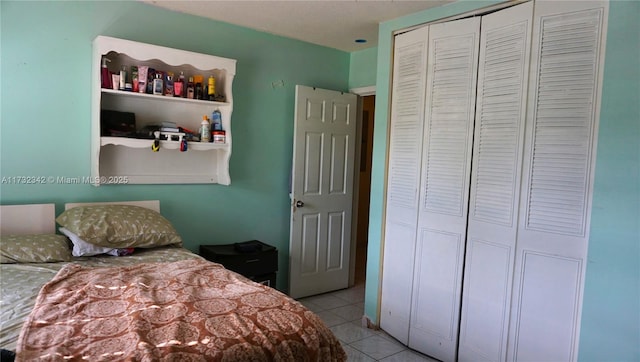 tiled bedroom featuring a closet